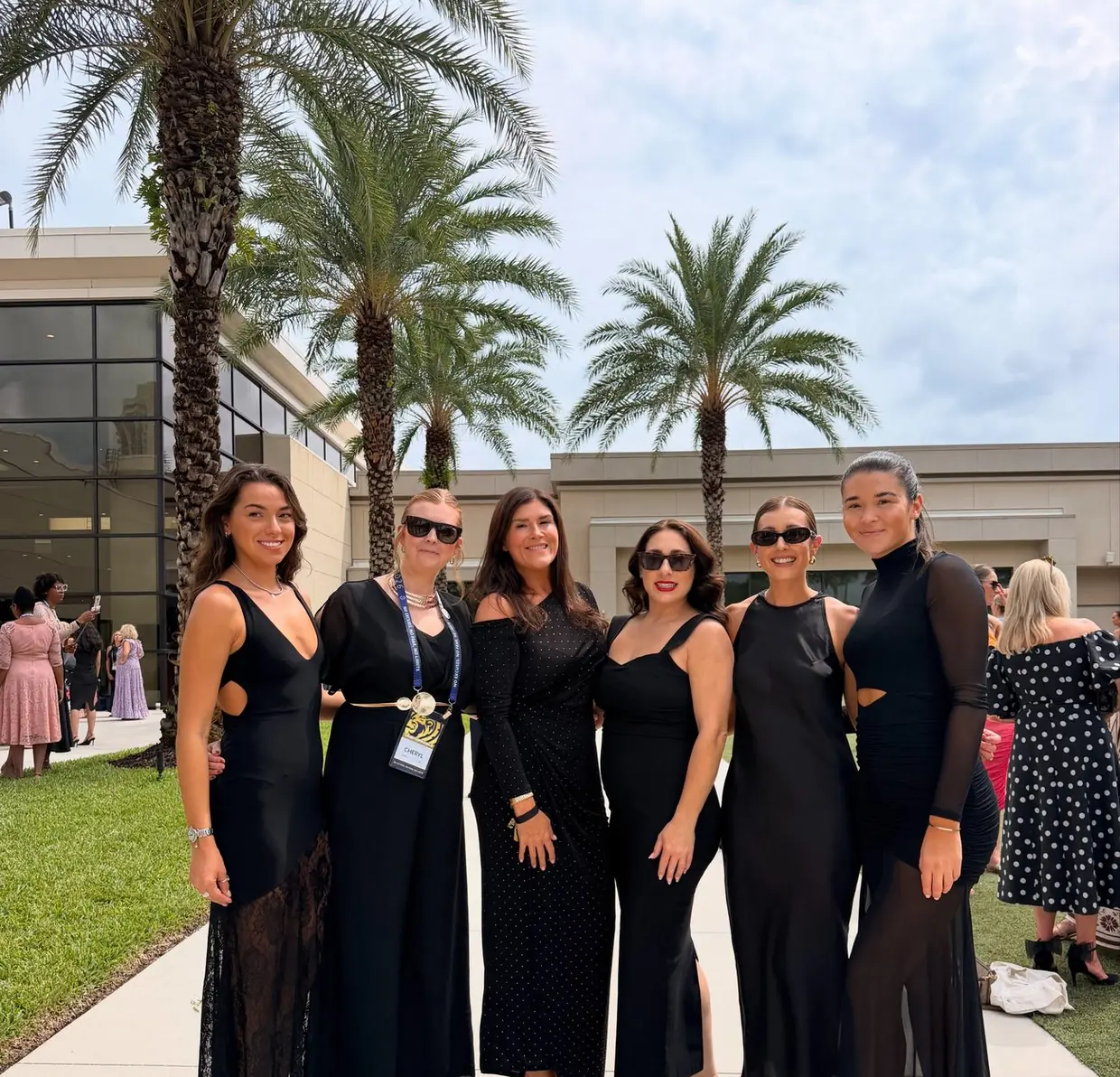 Renaé with five team members in black outfits at a travel business event